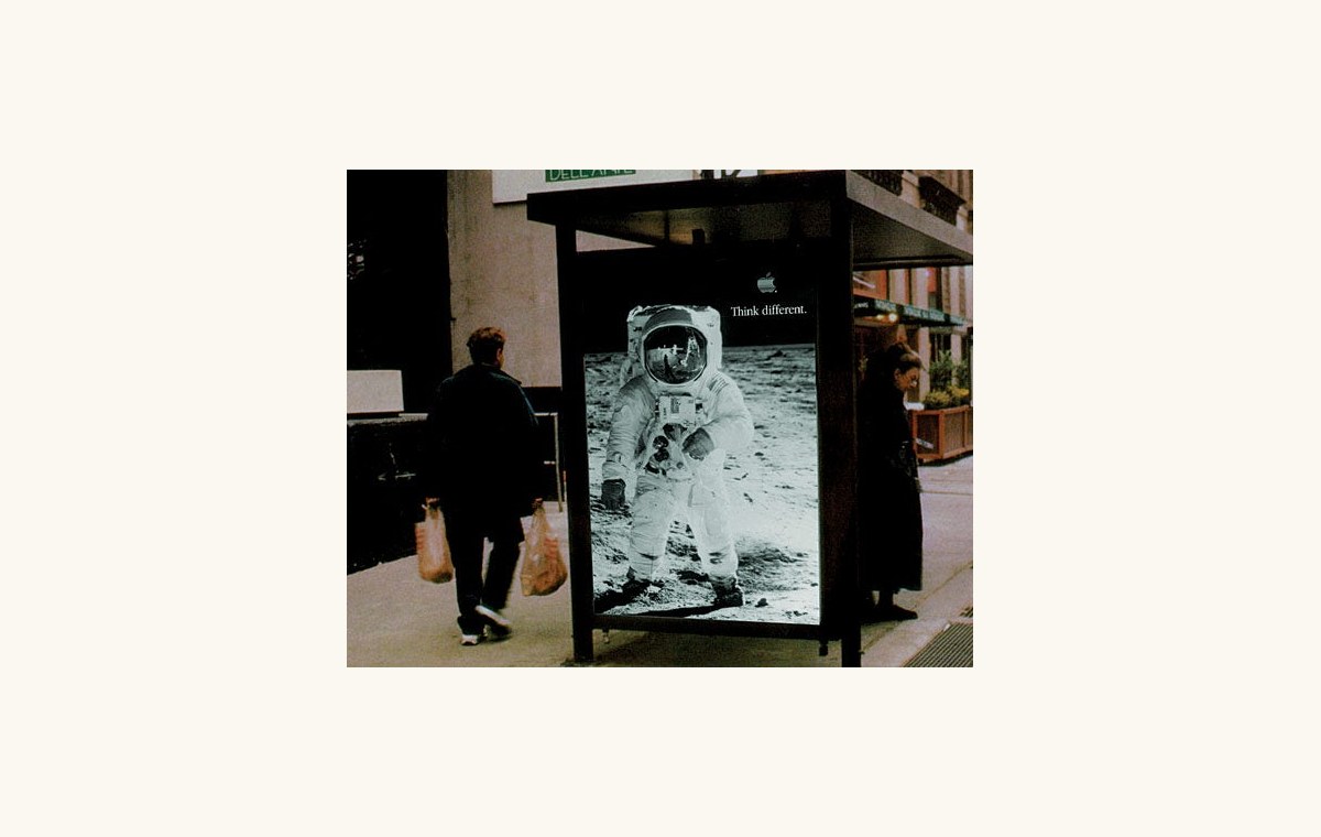 A 1997 Think Different poster displayed on a city street
